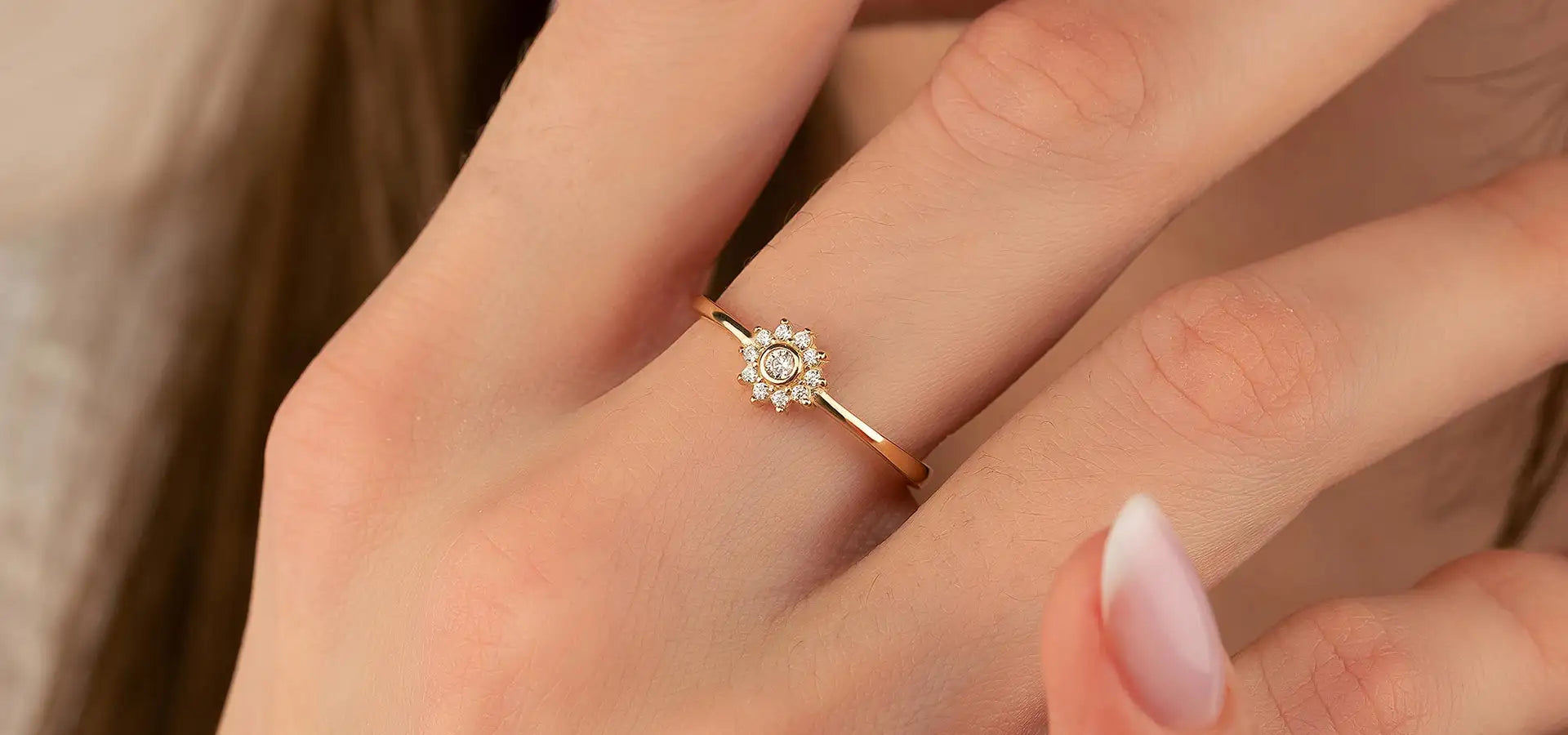 18-karat gold diamond engagement ring with a halo design.