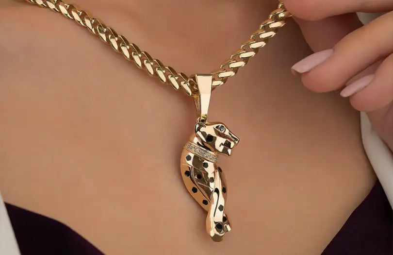 Gold panther pendant necklace with intricate detailing and diamond accents.