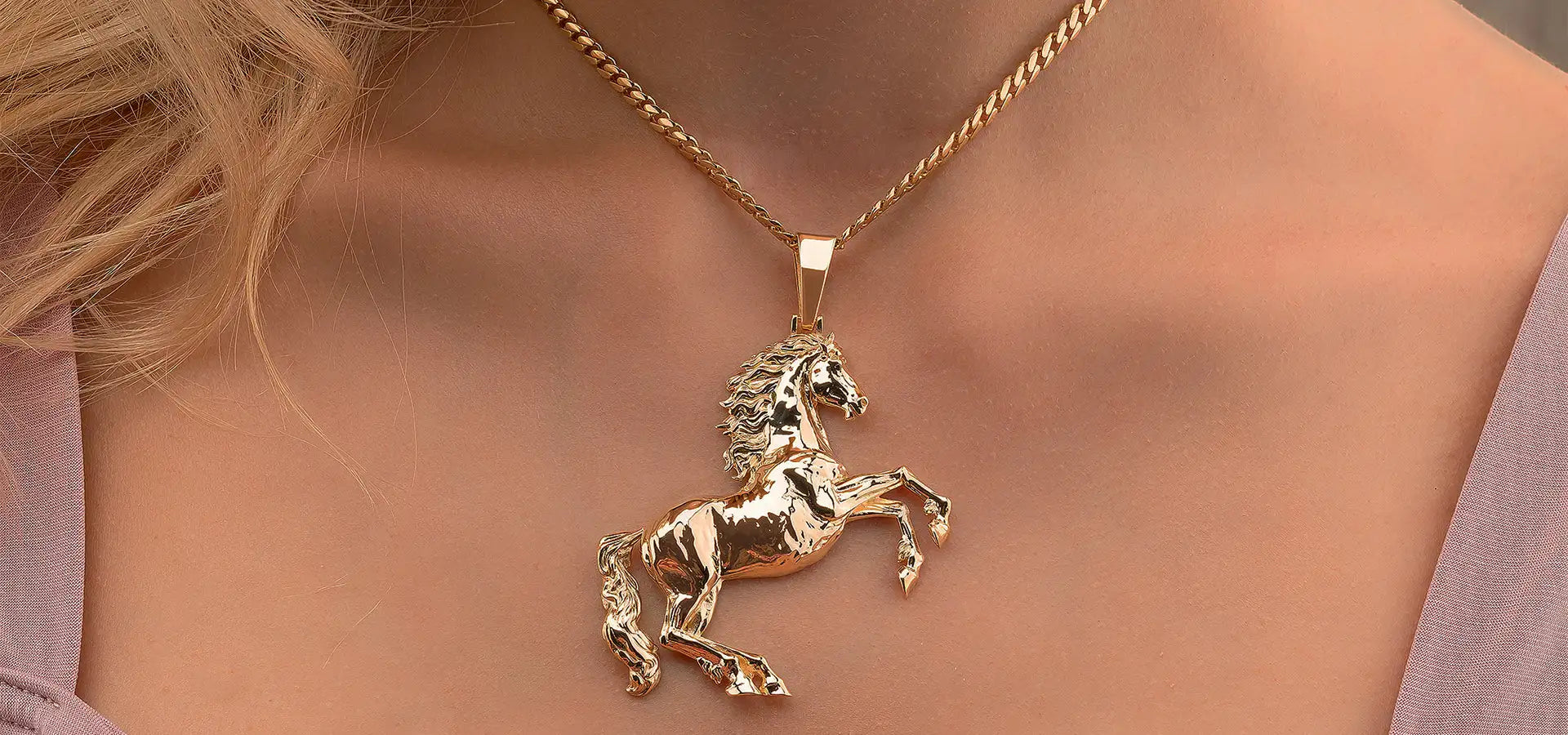 Gold unicorn pendant necklace with intricate details and a polished finish.